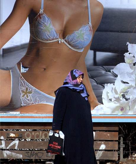 Muslimka kráí kolem billboardu, na kterém je reklama na spodní prádlo. Berlín, bezen 2006