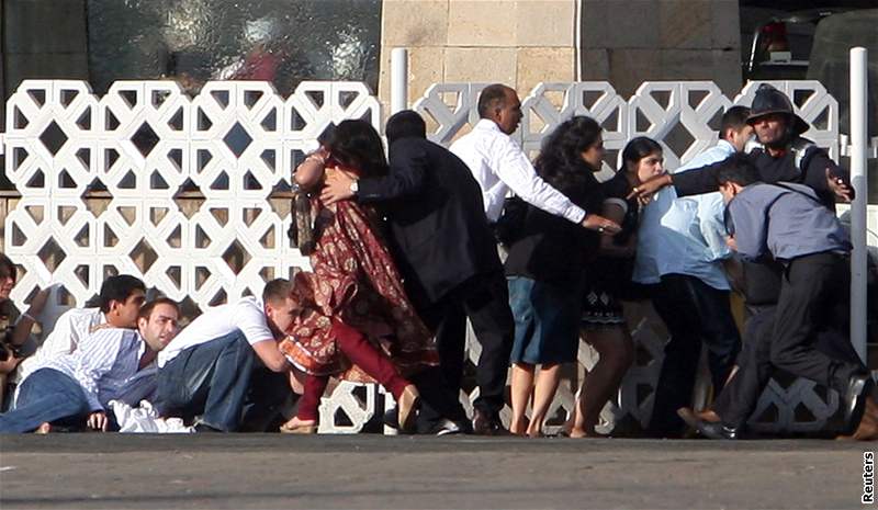 Lidé se krí pi stelb poblí hotelu Tád, na který zaútoili teroristé. (27. listopad 2008)