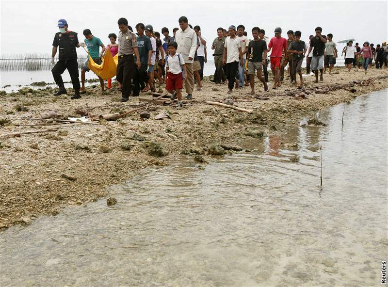 Policisté a záchranái nesou tlo cestujícího z indonéského trajektu, který se potopil v nedli. (13. leden 2009)