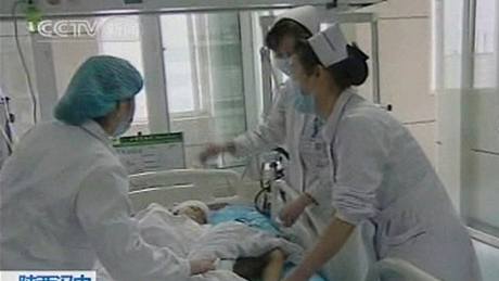 Lékai oetují jedno z dtí, které zranil útoník ve kolce v provincii an-si. (12. kvtna 2010)