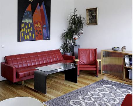 Obývací pokoj s normalizaní pohovkou Soa a pealounným keslem z tée éry
