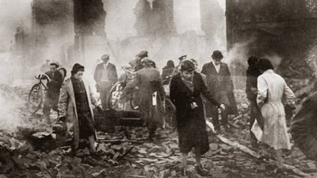 Ráno 17. listopadu 1940. Lidé procházejí troskami anglického msta Coventry.