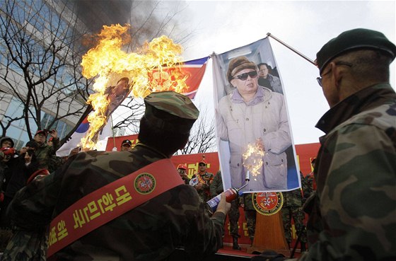 Asi tisícovka bývalých jihokorejských mariák protestovala proti severokorejskému útoku v Soulu, pálili pitom vlajky KLDR i portréty Kim ong-ila (27. listopadu 2010)