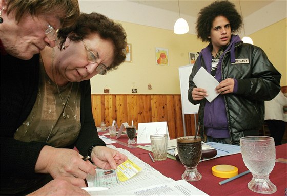 lenky volební komise si odkrtávají dalího volie se lutou kartikou, který se pihlásil k trvalému pobytu v Roudnici teprve v pátek.