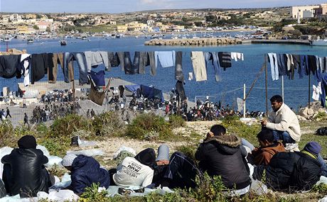 Uprchlíci z Tuniska ví prádlo na ostrov Lampedusa, na italském ostrov jich je tém est tisíc 