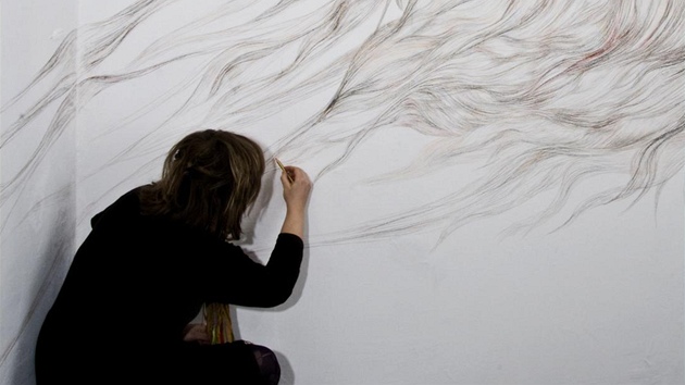 Filomena Borecká kreslí dílo na stnu Galerie Intuiti, rok 2010.