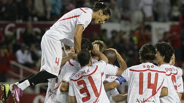 SKOK NA ZÁDA. Martin Cáceres (nejvýe) ze Sevilly skáe radostí na své spoluhráe poté, co Ivan Rakiti vstelil první gól zápasu s Villarrealem.