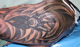 Detail tetování na levé pai mrtvého mue.