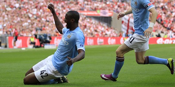 RADOST NA KOLENOU. Yaya Touré z Manchesteru City se raduje, práv vstelil jedinou branku ve finále FA Cupu. Slavit pibíhá i Adam Johnson.
