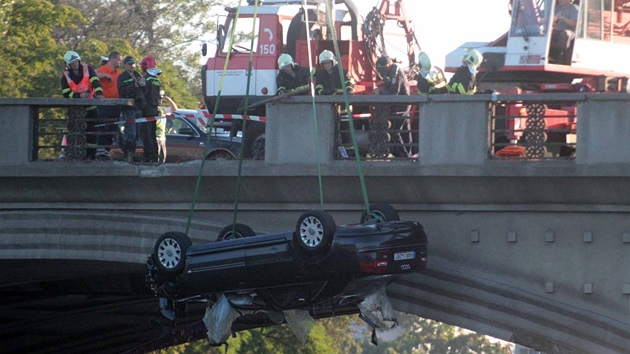 Auto, které po nehod na Hlávkov most prorazilo zábradlí a sjelo do Vltavy.