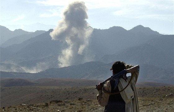 Afghánský bojovník sleduje ostelování skalního komplexu Tora Bora na hranicích