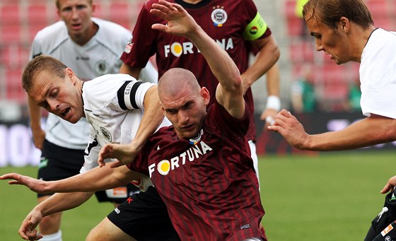 Sparanský fotbalista Martin Juhar v obklopení hradeckou pesilou.