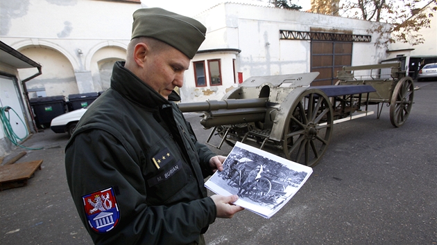 Michal Burian z Vojenskho historickho stavu stoj u historick lafety, kter vezla tak Masarykovy ostatky, a ukazuje historick fotografie (20. prosince 2011)