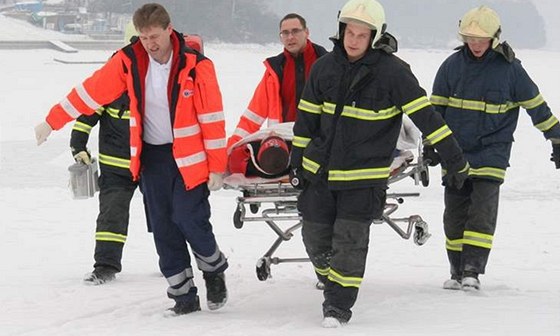 Pacienta sanitky zapadlé do závje pomáhali záchranám penést hasii. Ilustraní snímek