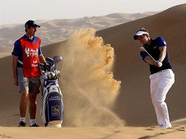 Svtová golfová jednika Luke Donald odpaluje míek v dunách Abú Zabí.