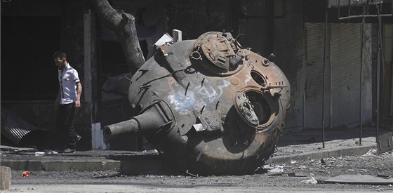 Syan míjí zbytky tanku, na kterém se skví arabský nápis "Svoboda" v