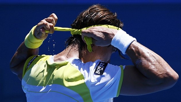POT. panlsk tenista David Ferrer si upravuje elenku a tee z n pot bhem osmifinle Australian Open.