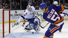 Frans Nielsen z NY Islanders posílá puk na branku Tampy Bay, gólman Anders