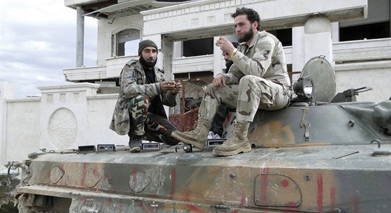 Povstalci ze Svobodné syrské armády, která bojuje proti reimu Baára Asada, jedí na tanku v Aleppu. Tank díve patil práv vládním armádním jednotkám. Ilustraní foto.
