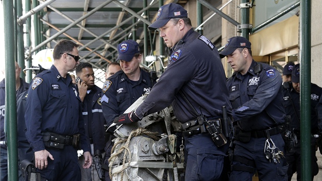 Policist pev kus podvozku z letadla, kter narazilo do dvojat. (2. kvtna 2013)