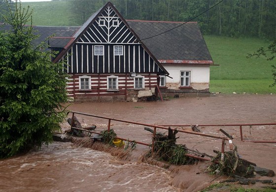 Voda se ene kolem roubenky v Rudníku (erven 2013).