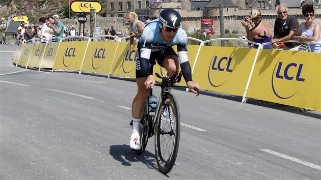 Mark Cavendish bhem asovky na Tour de France s monumentem Mont St. Michel v pozad.