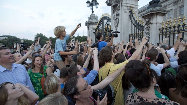 Britov ped Buckinghamskm palcem se sna vyfotit oznmen o narozen nslednka trnu. (22. ervence 2013)