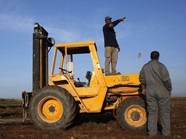 Farm worker Mustapha El-Mezroui gives directions to day labourers as he waits...