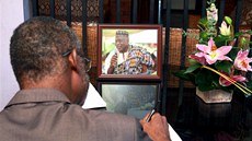 Lidé se podepisují do kondolenní knihy v dom ghanského básníka Kofi Awoonora