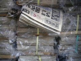 Copies of Fukushima Minpo newspapers with headlines "M(magnitude) 8.8, largest...