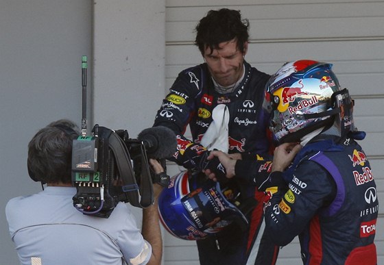 GRATULACE. Mark Webber (bez helmy) blahopeje Sebastianu Vettelovi k vítzství