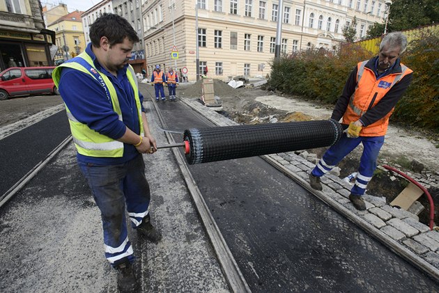 Dlníci pokládají speciální míku na Moskevské ulici.