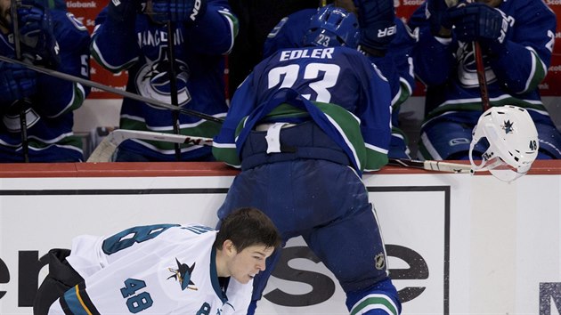 Tom Hertl (vlevo) ze San Jose piel o helmu v souboji s Alexanderem Edlerem z Vancouveru.