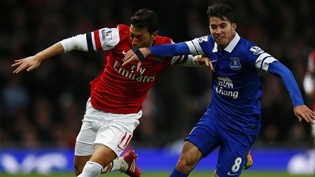 SOUBOJ. Mesut zil z Arsenalu (vlevo) a Bryan Oviedo z Evertonu v souboji pi utkn anglick ligy.