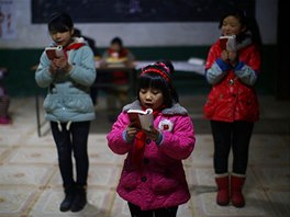 Students read a lecture from Mao Zedong's "Little Red Book" at the Democracy...