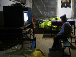 A student watches a film about Mao Zedong in a dormitory at the Democracy...