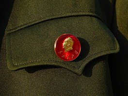 A student wears a pin button of China's late chairman Mao Zedong during a...