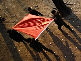 Students carry a Chinese flag during a ceremony at the Democracy Elementary and...