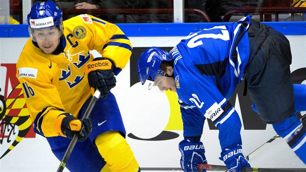 vdsk hokejista Filip Forsberg (vlevo) ujd s pukem na holi, zatmco Henri Ikonen z Finska pad.
