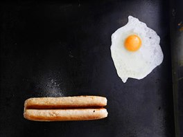 An egg and a sausage fry on a grill in May's snack van along the A22 near...
