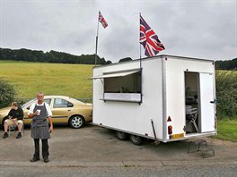 Danny, 51, poses for a photograph next to his snack trailer along the A69 near...