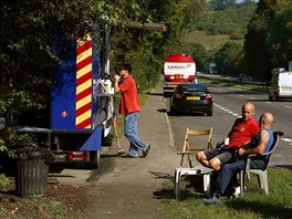 Workers take a break next to a snack van along the A22 near Caterham, southern...