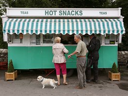 People wait outside a snack van along the A683 near High Casterton, northern...