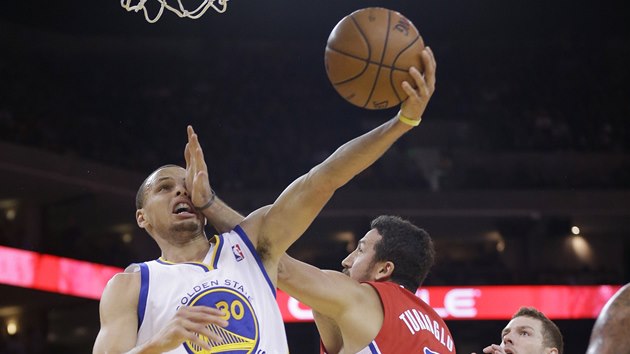 FACKA. Stephen Curry z Golden State zakonuje, fauluje ho Hedo Turkoglu z LA Clippers.