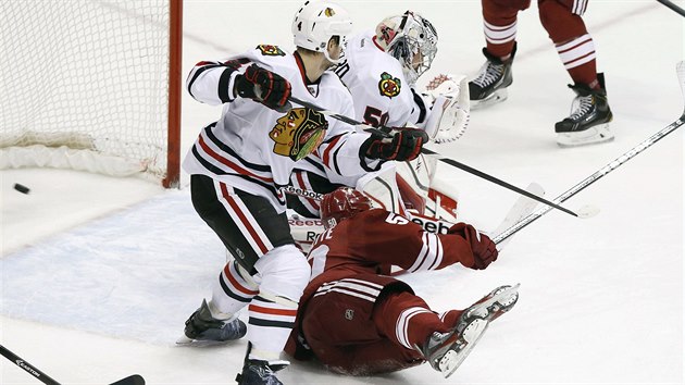 Chicagsk glman Corey Crawford prv dostv gl od Radima Vrbaty (na smmku jsou vidt jen jeho nohy). Snaha chicagskho Niklase Hjalmarssona (vlevo) je marn, na led pihl  Antoine Vermette.