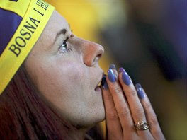 A fan of Bosnia and Herzegovina reacts after Argentina scores a goal during...