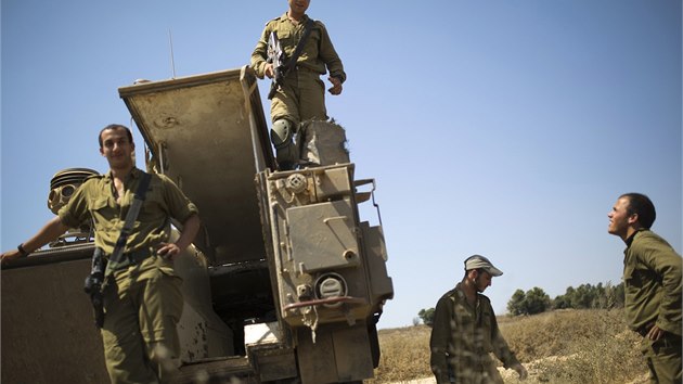 Izraelt vojci stoj na vrcholu obrnnho transportru pobl hranice psma Gazy (7. 7. 2014).