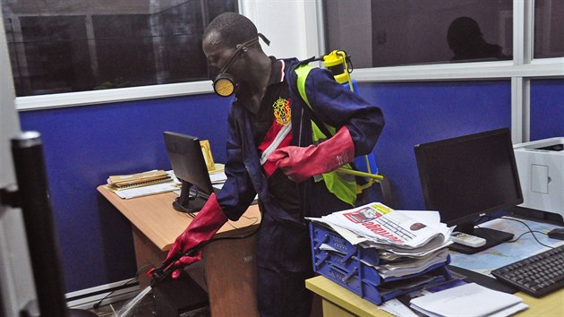 Pracovnk dezinfikuje kancel jedn ze spolenost sdlcch v liberijsk Monrovii, j zmt epidemie eboly (1. srpna 2014).