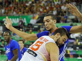 Marc Gasol (v bílém) ze panlska se tlaí do francouzského pivotmana Rudyho...