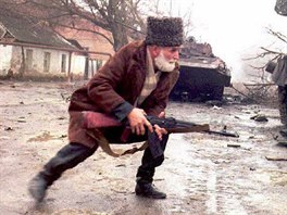 8 A Chechen volunteer takes cover behind a Russian tank 01 January 1995 during...